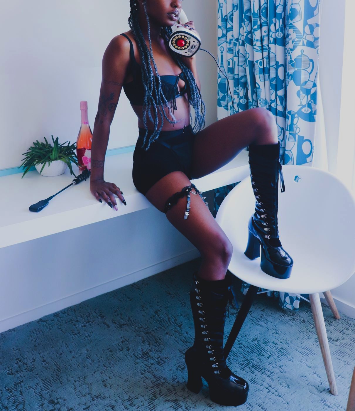 Kenna on a vintage phone in platform boots